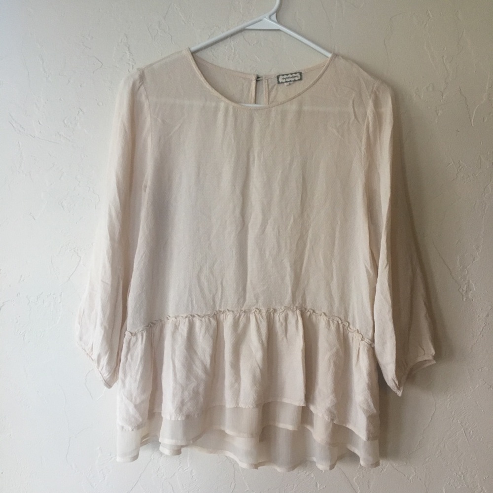 Cream blouse with ruffled bottom